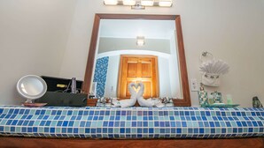 A bathroom with a large mirror, a vanity with a sink, a towel rack, and a blue tiled floor. - Sea Front Property - "Sea Turtle" pool/bikes included/tours! (San Pedro)