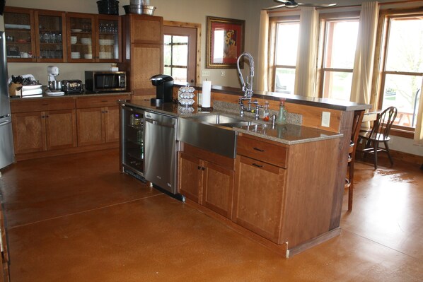 A kitchen with wooden cabinets, stainless steel appliances, and a granite countertop.