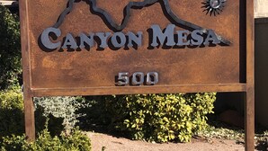 A metal sign with the text "Canyon Mesa 500" and a mountain design.