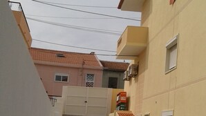 A narrow alleyway with patterned paving leading to a gated entrance. - Rio ... Beaches ... Lisbon, Ideal for families with children and pets. (Almada)