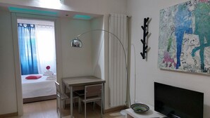 A small, well-lit room with a bed, a desk, a television, and a map on the wall. - Foscolo 1, 100m from the beach (Viareggio)