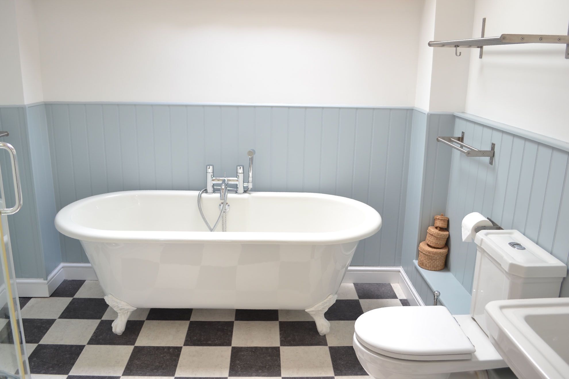 Ein Badezimmer mit freistehender Badewanne, Toilette und Waschbecken.