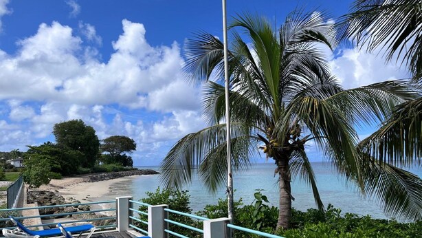 A beachside lounge with blue lounge chairs and a view of the ocean. - Villa Valeda on the hill (Saint James)