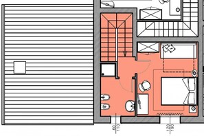 Plano de planta de una habitación de hotel con cama, escritorio, silla, una mesita y baño.