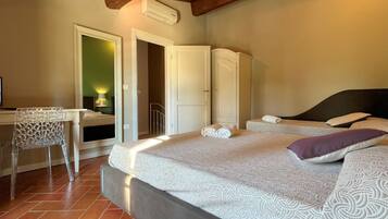 A bedroom with a bed, a desk, and a chair.