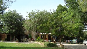 Un barrio residencial con una casa, un pequeño jardín y un automóvil estacionado.