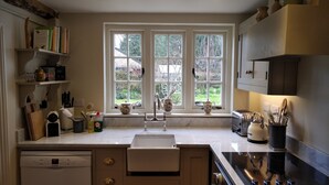 A kitchen with a dishwasher, stove, and a window with a view of the garden. - Nr Devizes, Marlborough & Bath, , walled garden (Seend)