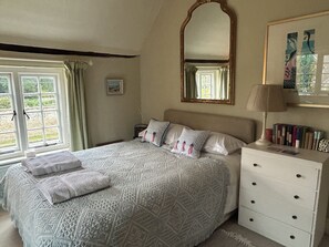 A bedroom with a large bed, a bedside table with a lamp, a dresser, and a window with curtains. - Nr Devizes, Marlborough & Bath, , walled garden (Seend)