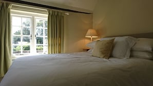 A bedroom with a large bed, a window with curtains, and a bedside lamp. - Nr Devizes, Marlborough & Bath, , walled garden (Seend)