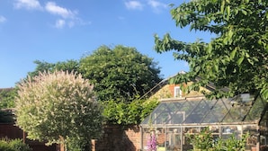 A greenhouse surrounded by a garden with various plants and flowers. - Nr Devizes, Marlborough & Bath, , walled garden (Seend)