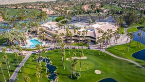 An aerial view of a golf course with a large building, palm trees, and a swimming pool. - 
FUN IN SUN, GOLF&TEN.FEB-MARCH, PALM DESERT, PALM VALLEY CC. 55-Day Minimum
   (Palm Desert)