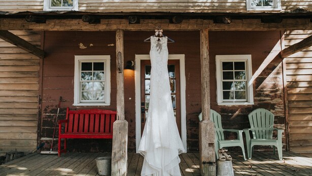 A rustic wooden house with a porch, a red bench, and two green Adirondack chairs. - Historical Farm Cottage Retreat near Clemson (Westminster)
