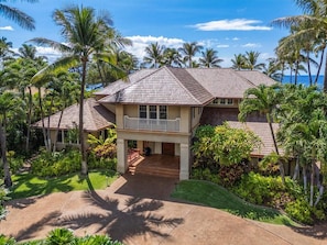 A two-story house with a covered porch and a view of the ocean. - Luxury, Beachfront- Ka'anapali Beach, Pool & Hot Tub! (Lahaina)