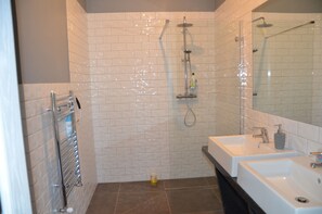 Bathtub, hair dryer, towels, toilet paper