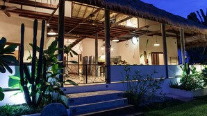 A modern house with a covered porch, a kitchen area, and a dining space. - 2 Private Tropical villas, 10 bedrooms, Event & Yoga space,  for + 20 guests! (koh pha ngan)