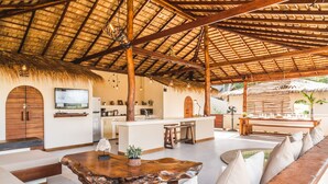 A spacious living area with a thatched roof, wooden furniture, and a central island. - 2 Private Tropical villas, 10 bedrooms, Event & Yoga space,  for + 20 guests! (koh pha ngan)