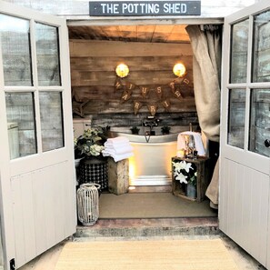 Cozy retreat with a wooden interior, small sink, and a decorative banner.