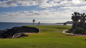 A golf course with a view of the ocean and a mountain in the distance. - APARTMENT WITH PRIVATE SOLARIUM ON THE LAST FLOOR, WiFi, HEATED POOLS, (TENERIFE)