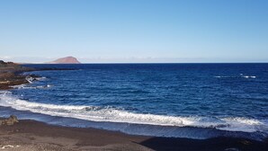A coastal landscape with a clear view of the ocean and a distant mountain. - APARTMENT WITH PRIVATE SOLARIUM ON THE LAST FLOOR, WiFi, HEATED POOLS, (TENERIFE)