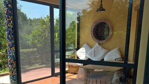 A covered patio area with a sliding glass door leading to an outdoor seating area. - Vacation House "La Caprignola" (Buccino)