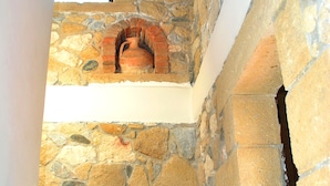 A stone staircase leading to a fireplace with a stone wall and a window above. - Sea-view villa, 1.5 km from beaches, private heated pool (optional). (KONTOMARI)