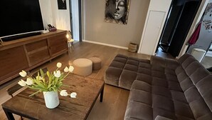 A living room with a wooden coffee table, a brown sofa, a flat-screen TV, and a painting on the wall. - PRETTY FAMILY HOUSE IN PROVENCE (Éguilles)