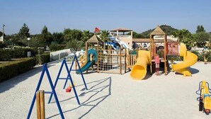 A playground with slides and climbing structures.
