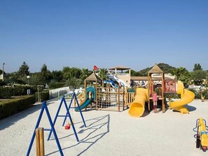 A playground with slides and climbing structures.