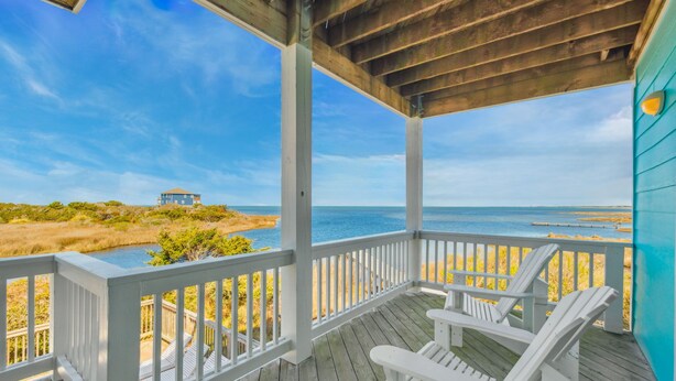 A wooden deck with white railings overlooking a beach and ocean. - Premier Soundfront Dog Friendly w/ Pool, Hot Tub, Theater and Game Rooms, More (Hatteras)