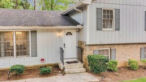 A two-story house with a front porch, a small front yard, and a mailbox. - Group retreat with deck, sleeps 12 (Lithonia)