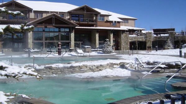 Relax by the heated outdoor pool surrounded by lounge chairs and stone steps.