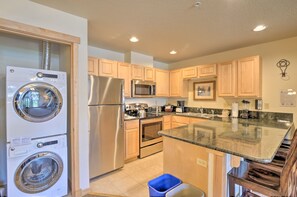 Enjoy cooking in this well-equipped kitchen with a large island and washer and dryer.
