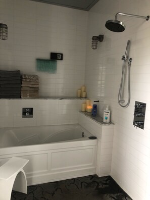 Bathtub, hair dryer, towels, soap