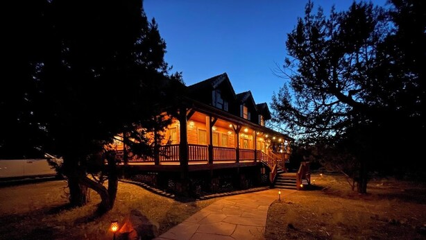 A two-story house with a porch and a stone pathway leading to the front door. - Sugar Knoll Lodge / 3 Story, 5bdr, HOT TUB, East Zion, Bryce and Grand Canyon  (Orderville)