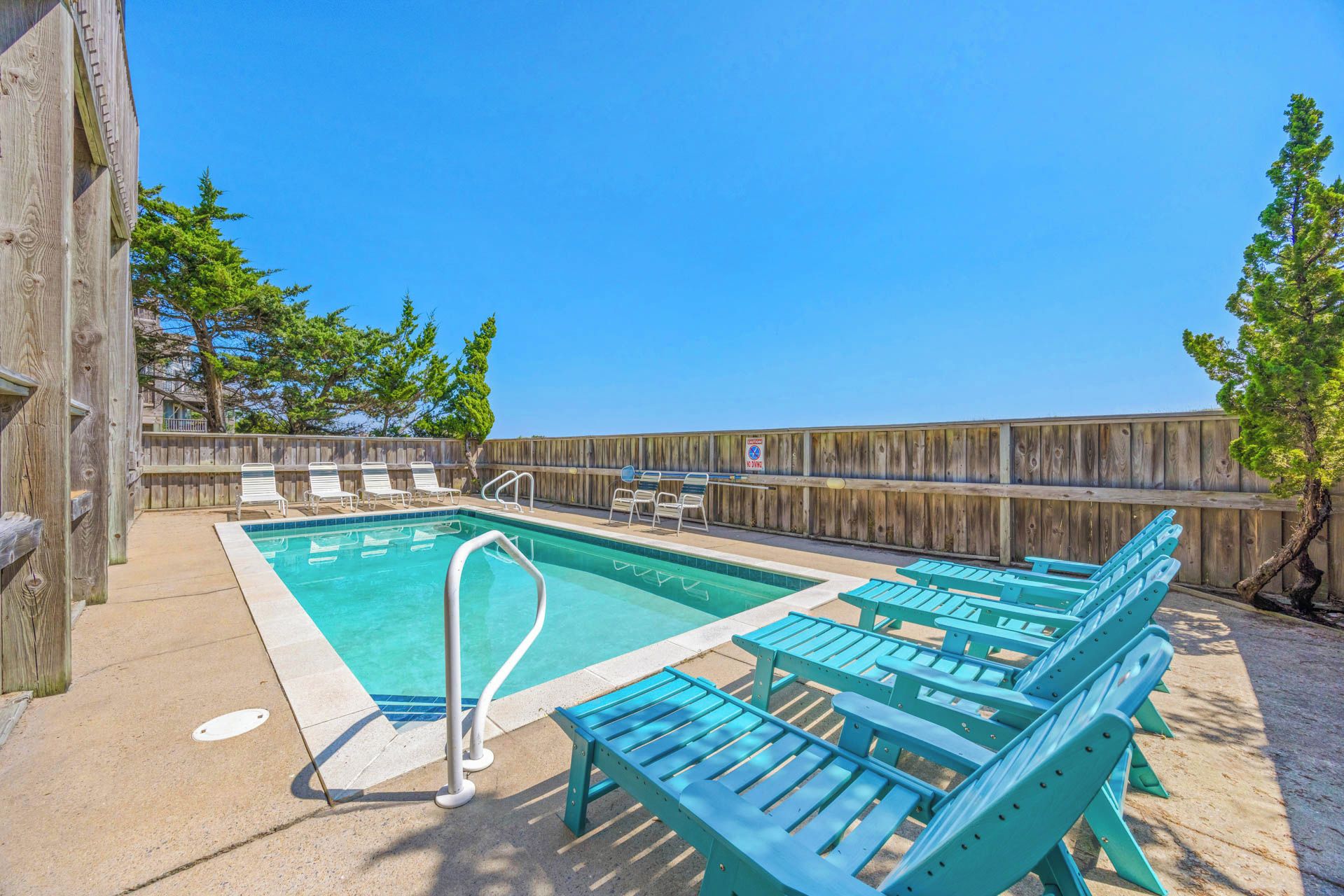 Dive into your private oasis—a sparkling pool surrounded by sun-warmed loungers, where you can soak up the coastal breeze and unwind under bright blue skies.