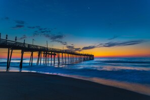 Walk along the pier and enjoy the serene views of the calm waters.
