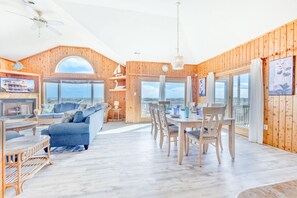 Enjoy a panoramic view from the large window, a comfortable seating area, and a fireplace in this stylish room.