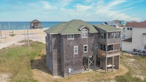 A two-story house with a balcony, located near a beach. - Semi-Oceanfront Home w/ Hot Tub, Smart TVs, Community Tennis/Pickleball Courts (Rodanthe)