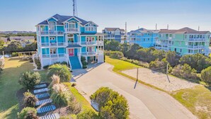 A multi-story residential building with a prominent antenna. - Premier Oceanview Dog Friendly w/ Pool, Hot Tub, Elevator, EV Charger, Much More (Rodanthe)
