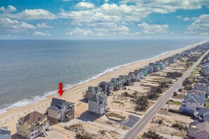 A coastal residential area with houses along the beach and a road running parallel to the shore. - Oceanfront Dog Friendly w/ Hot Tub, Theater, Community Pool & Tennis/Pickleball (Avon)