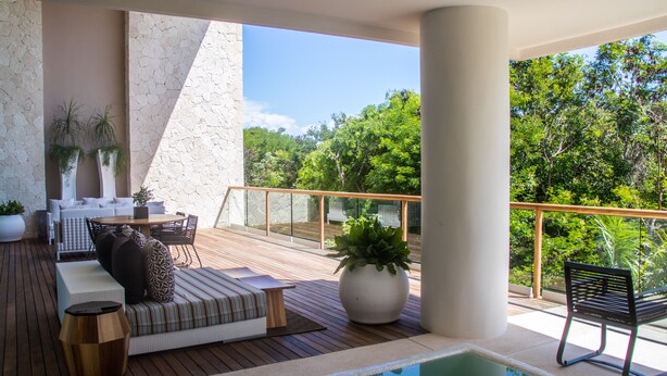 A modern outdoor lounge area with a pool, wooden deck, and seating arrangements. - Grand Luxxe Riviera Maya 3 Bedroom Residence (SPRING BREAK 2020 - 3/14-21) (Riviera Maya)