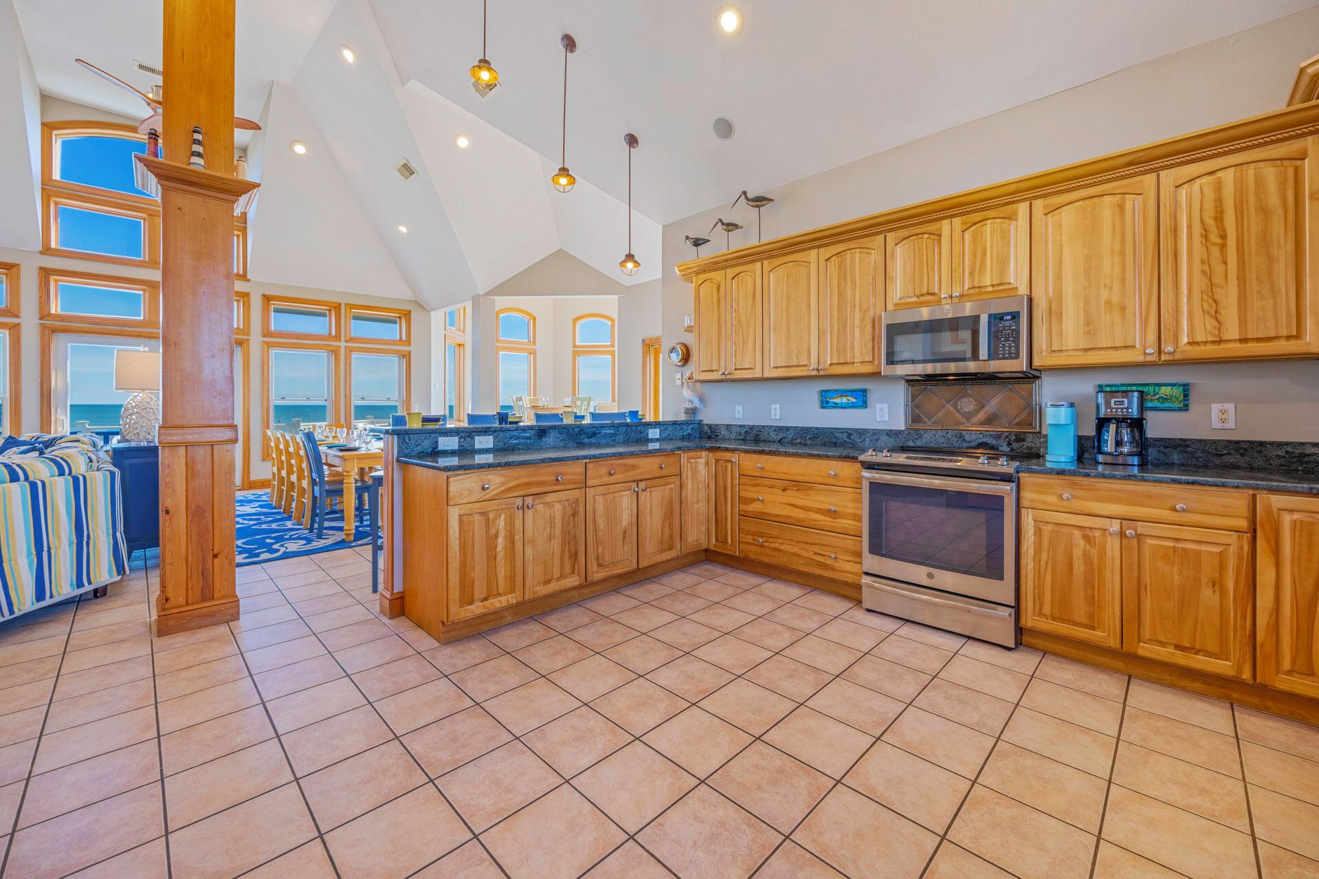 A spacious kitchen with wooden cabinets, a large island, and modern appliances.