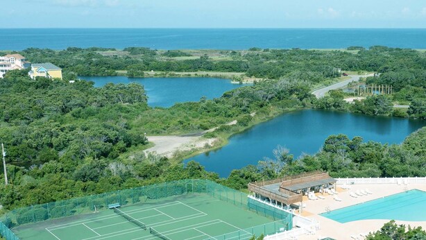 A tennis court, a swimming pool, and a view of the ocean. - Oceanfront Home with Direct Beach Access, Community Pool and Tennis/Pickleball (Avon)