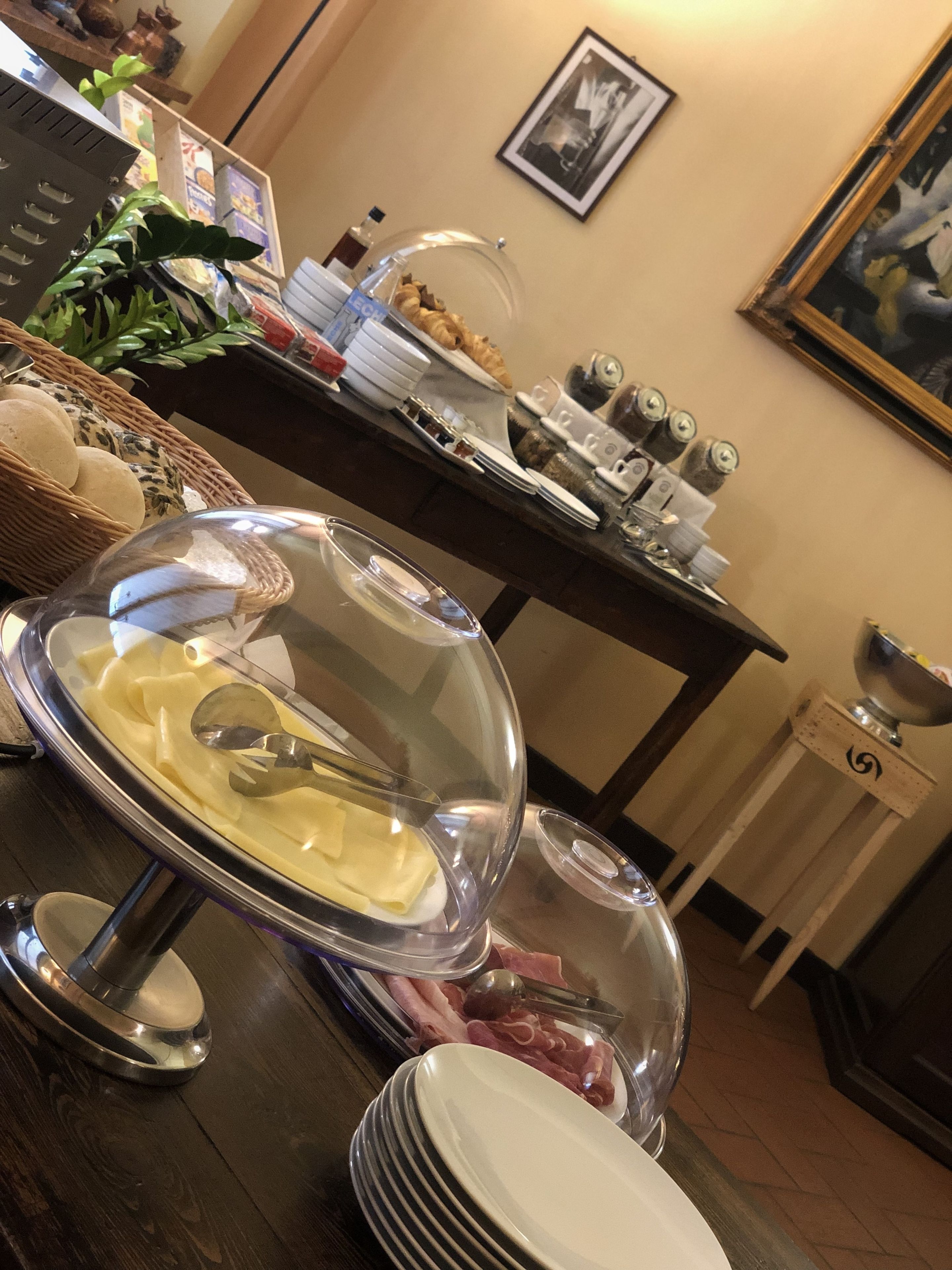 A buffet setup with a variety of food items, including pasta, meats, and condiments.