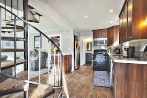 A modern kitchen with wooden cabinets, stainless steel appliances, and a built-in microwave. - Bubba's Blue Bungalow WALK to Lifts and Main St (Park City)