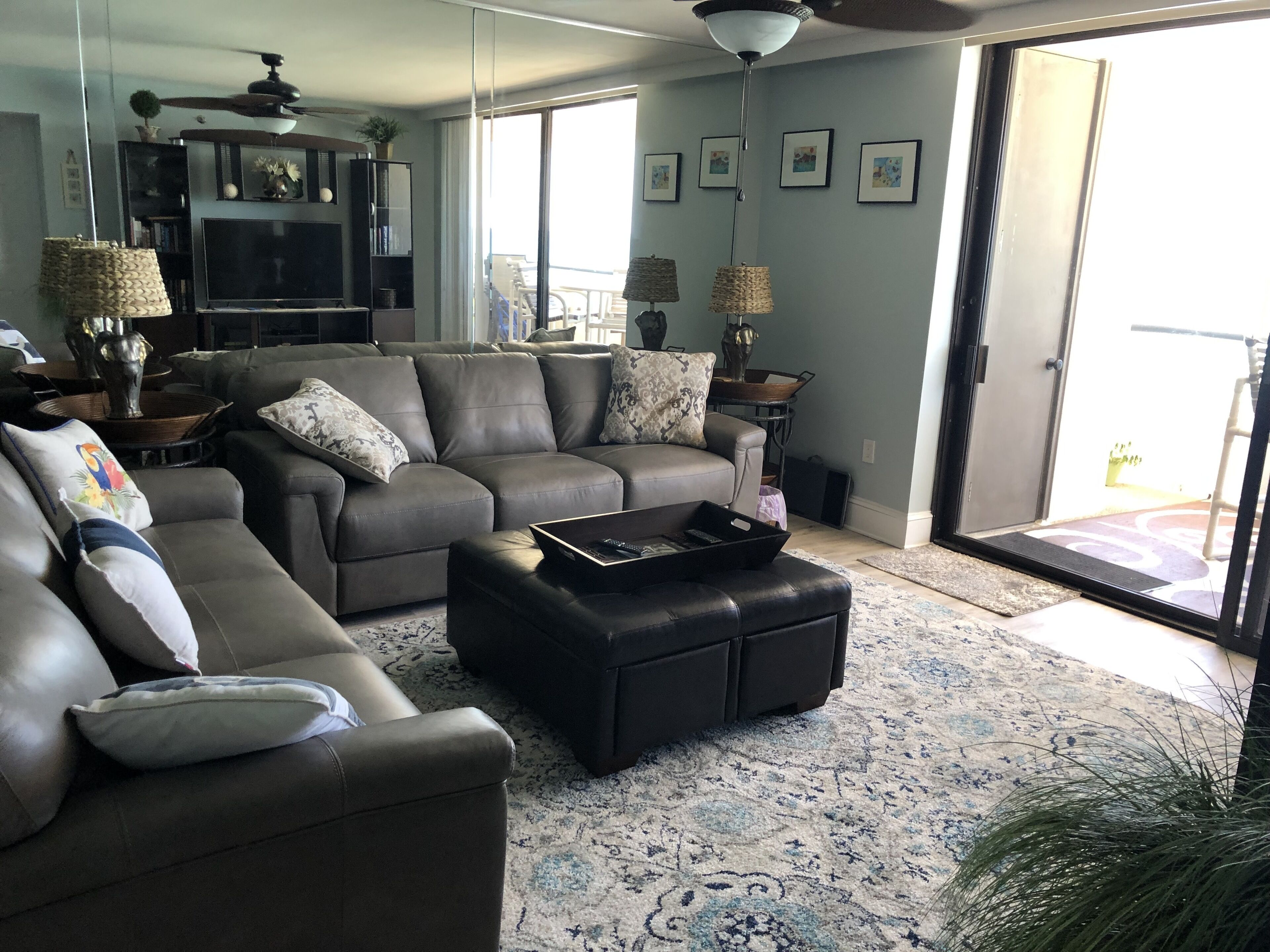 A spacious living room with a sectional sofa, a coffee table, and a television.