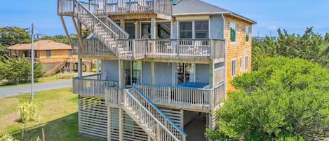 A multi-story building with a balcony and a staircase.
