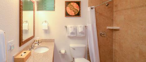 A bathroom with a sink, toilet, and shower.