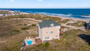 A two-story house with a pool, located near a beach and ocean. - Semi-Oceanfront Dog Friendly w/ Private Pool, Hot Tub, Game and Media Rooms (Rodanthe)