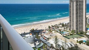 A high-rise hotel overlooking a beach with a clear view of the ocean. - Orchid Residences' Apartment 22306 redefines luxury (Surfers Paradise)